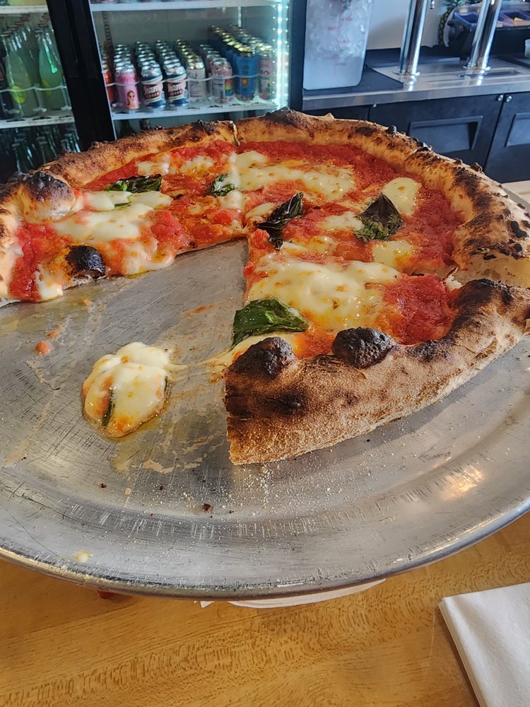 Margherita pie, fresh basil on mozzarella
